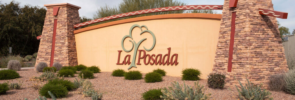 La Posada entrance sign with brick pillars.