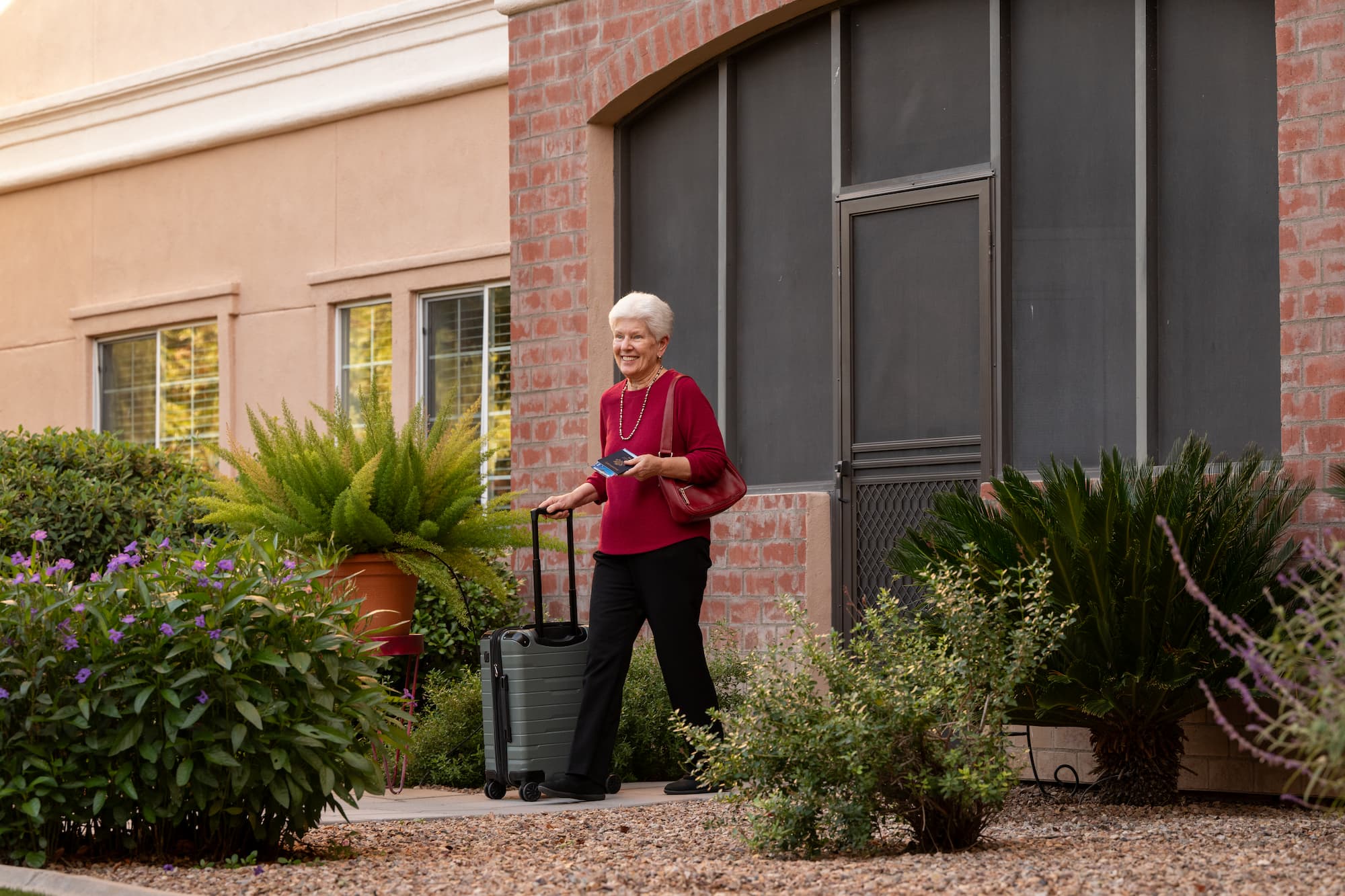 senior woman has her suitcase packed and is ready to travel
