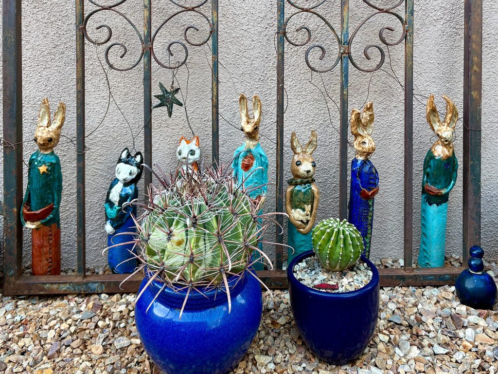 A bunch of ceramic pieces of animals on a gate found in La Posada Green Valley 